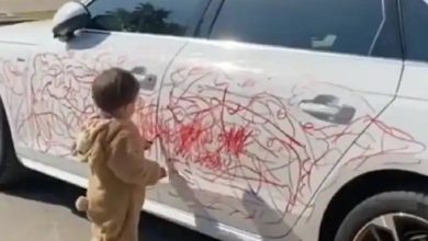 Little Boy Scribbles On White Car