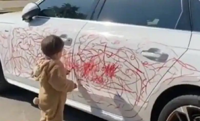 Little Boy Scribbles On White Car